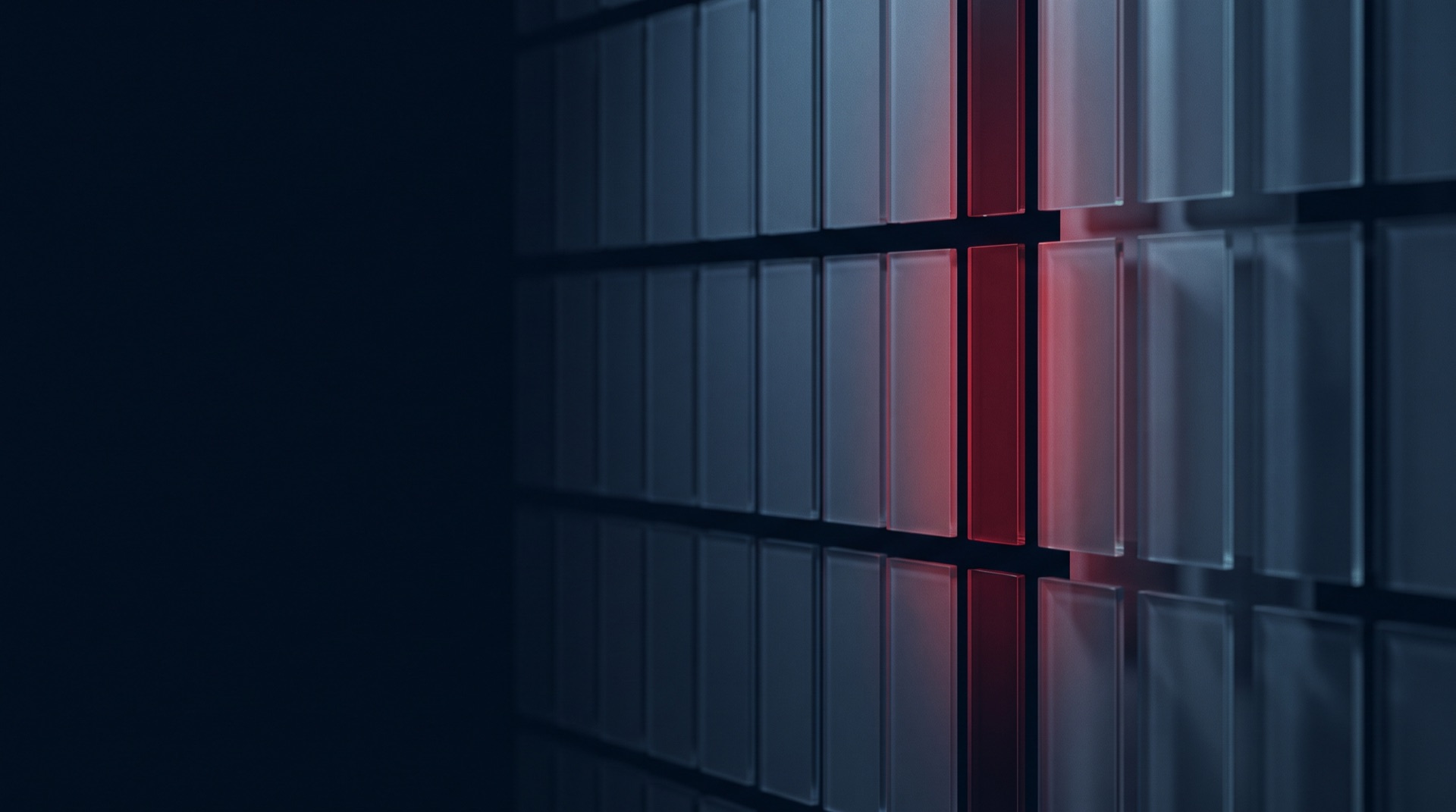 A dark grid of glass panels receding into shadow, with a single column lit in red — evoking the selection of one vendor from many.